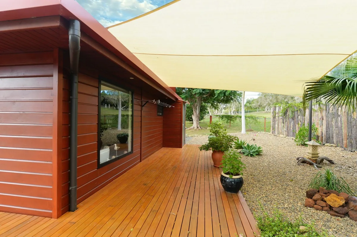 Illustrative wooden deck with a shaded sitting area and garden